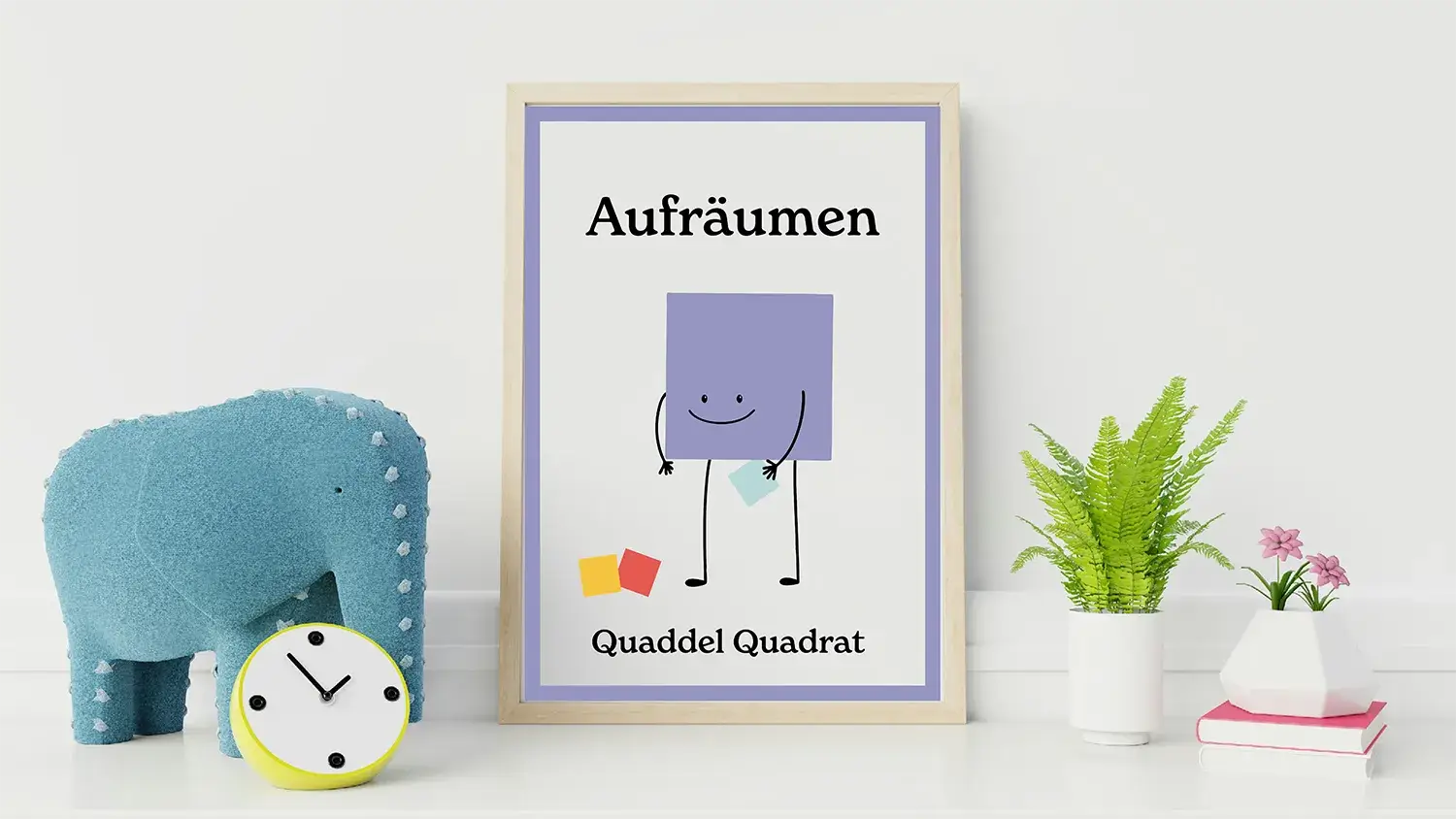 Poster mit "Quaddel Quadrat" und dem Wort "Aufräumen" neben Deko-Elementen